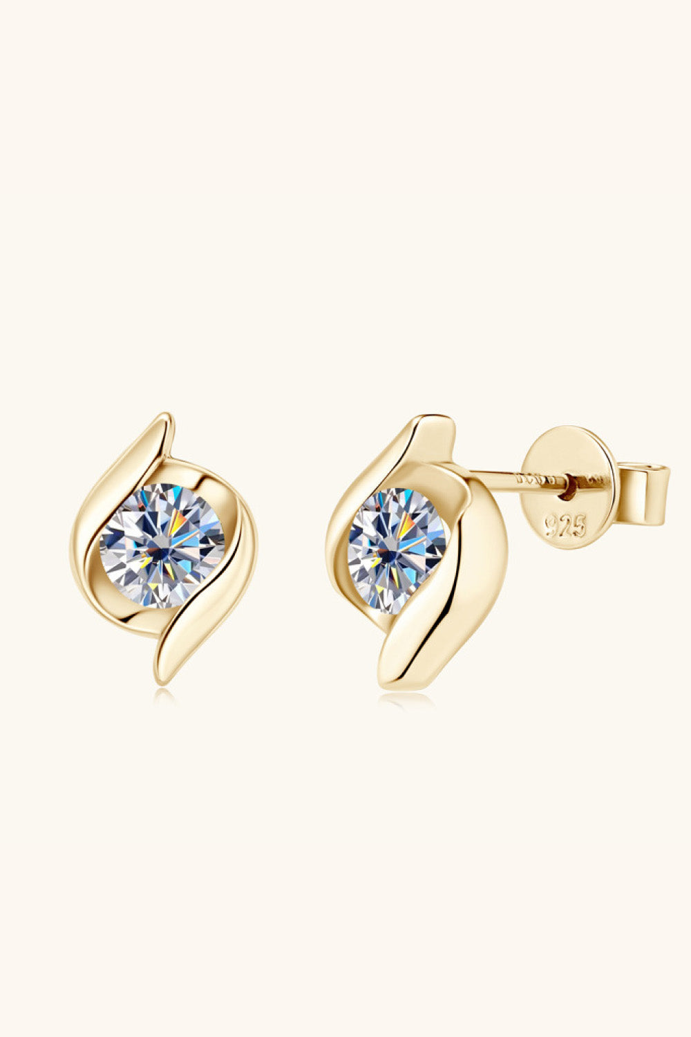 Gold earrings with clear gemstones on a white background