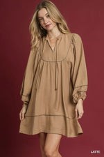 Woman wearing a brown dress against a red background