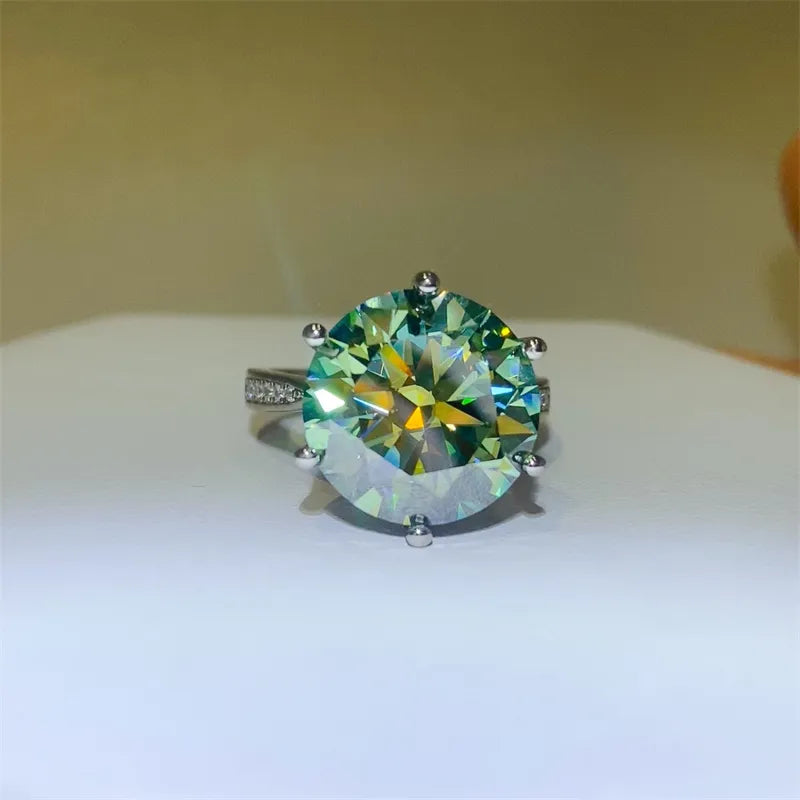 Ring with a large green gemstone on a white surface