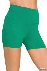 Green athletic shorts on a white background