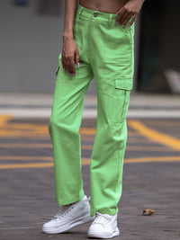 Person wearing bright green pants and white sneakers on a blurred background