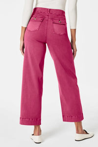 Person wearing bright pink pants on a white background