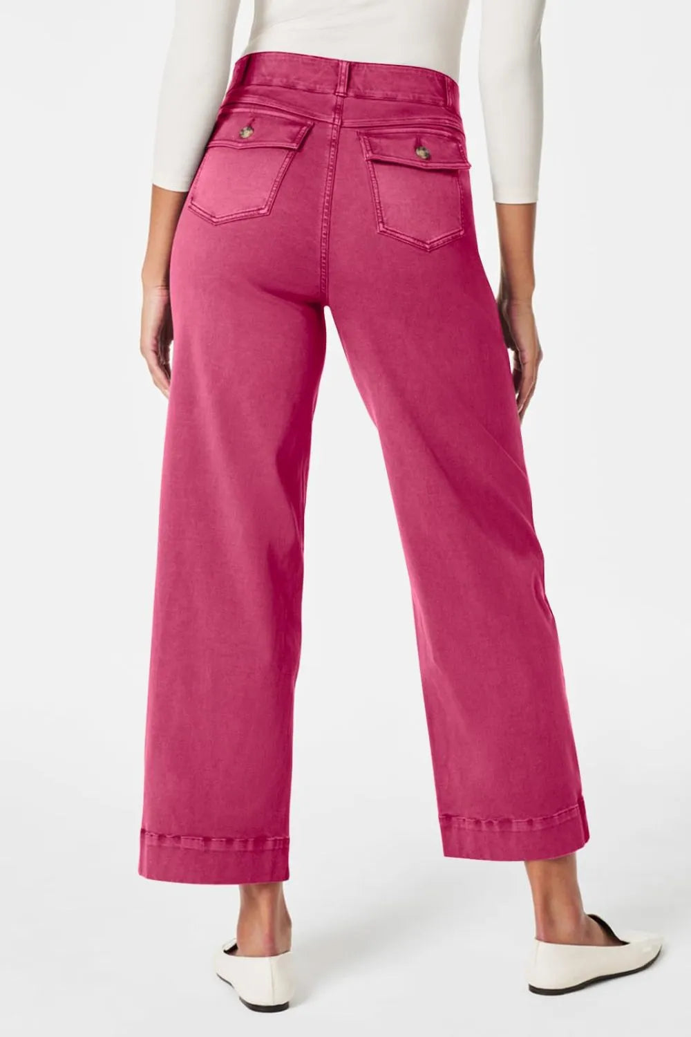 Person wearing bright pink pants on a white background