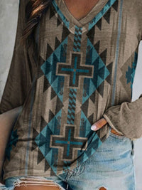 Close-up of a person wearing a patterned hoodie with a cross design.