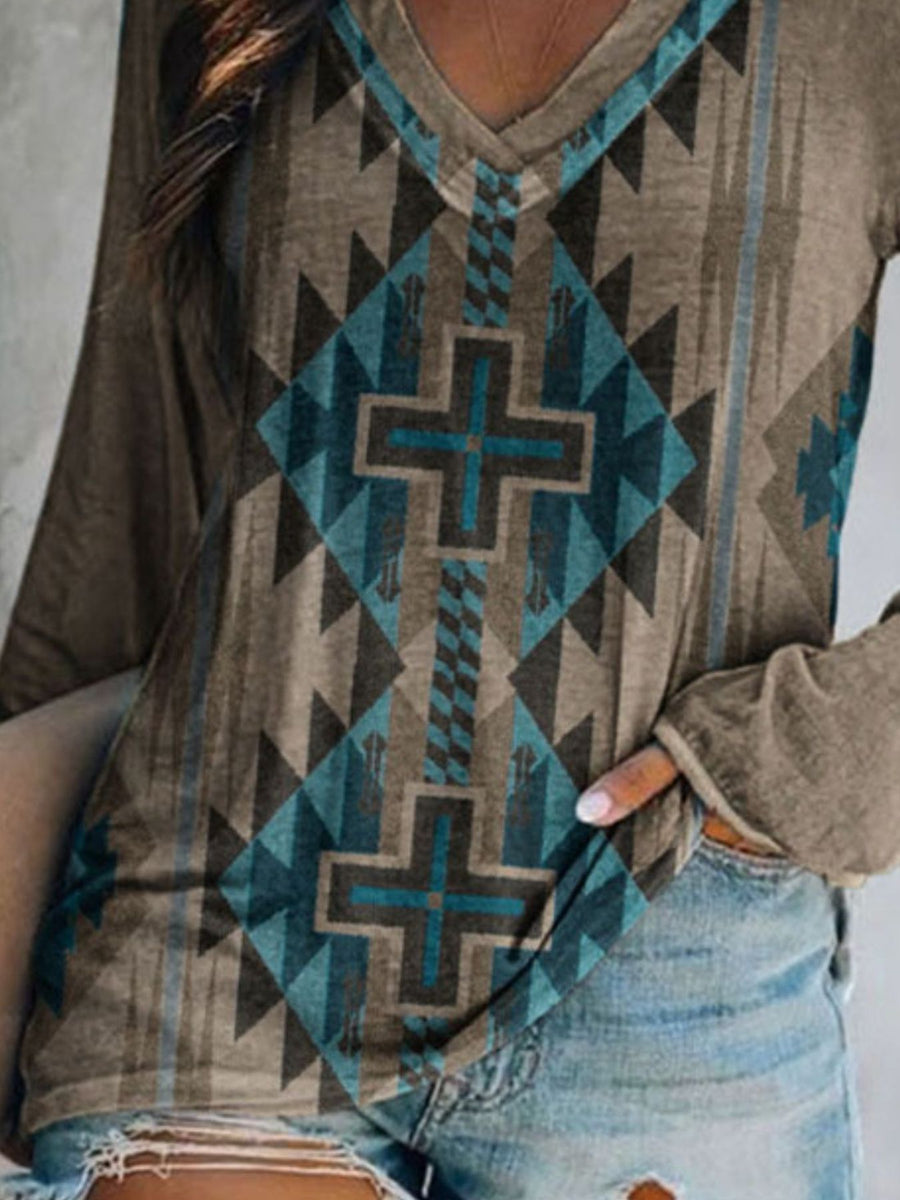Close-up of a person wearing a patterned hoodie with a cross design.