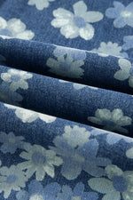 Close-up of blue floral fabric with white flowers