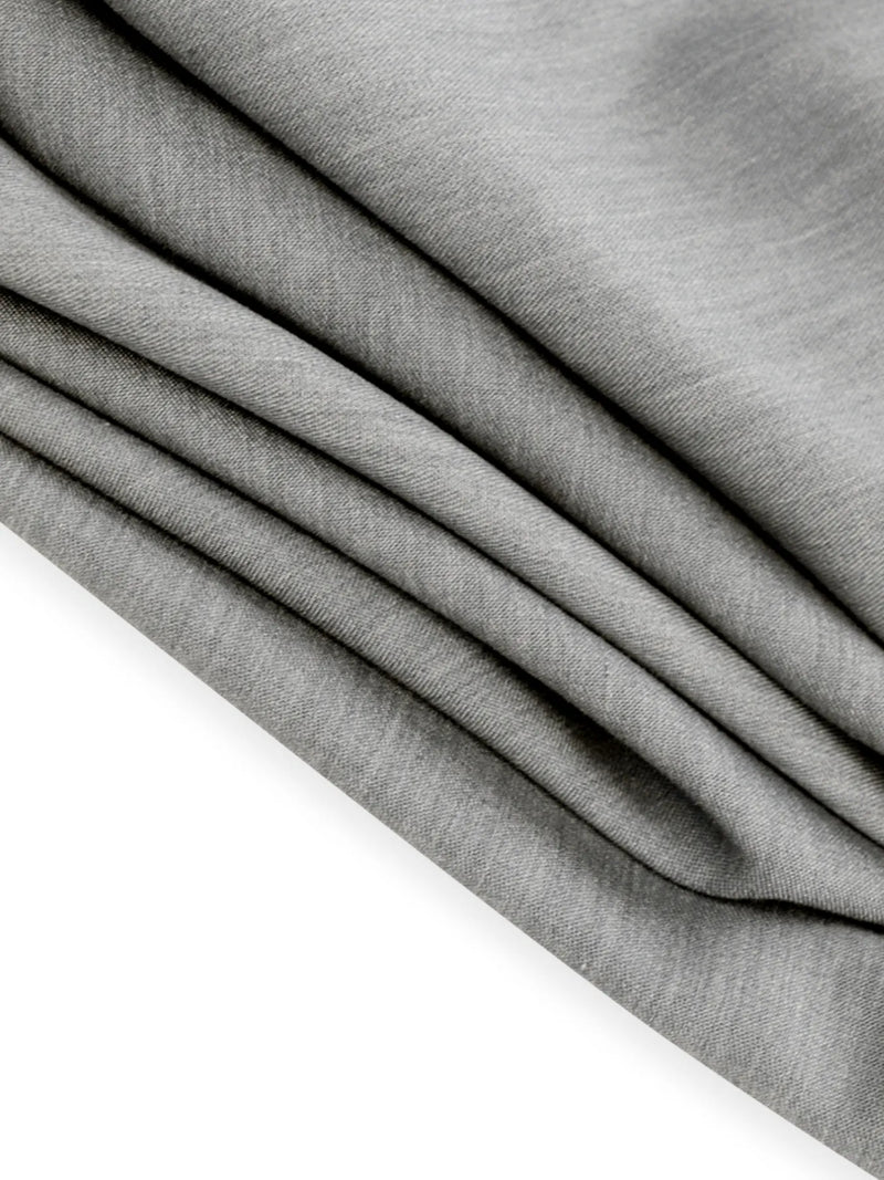 Close-up of gray fabric with a slight texture on a white background