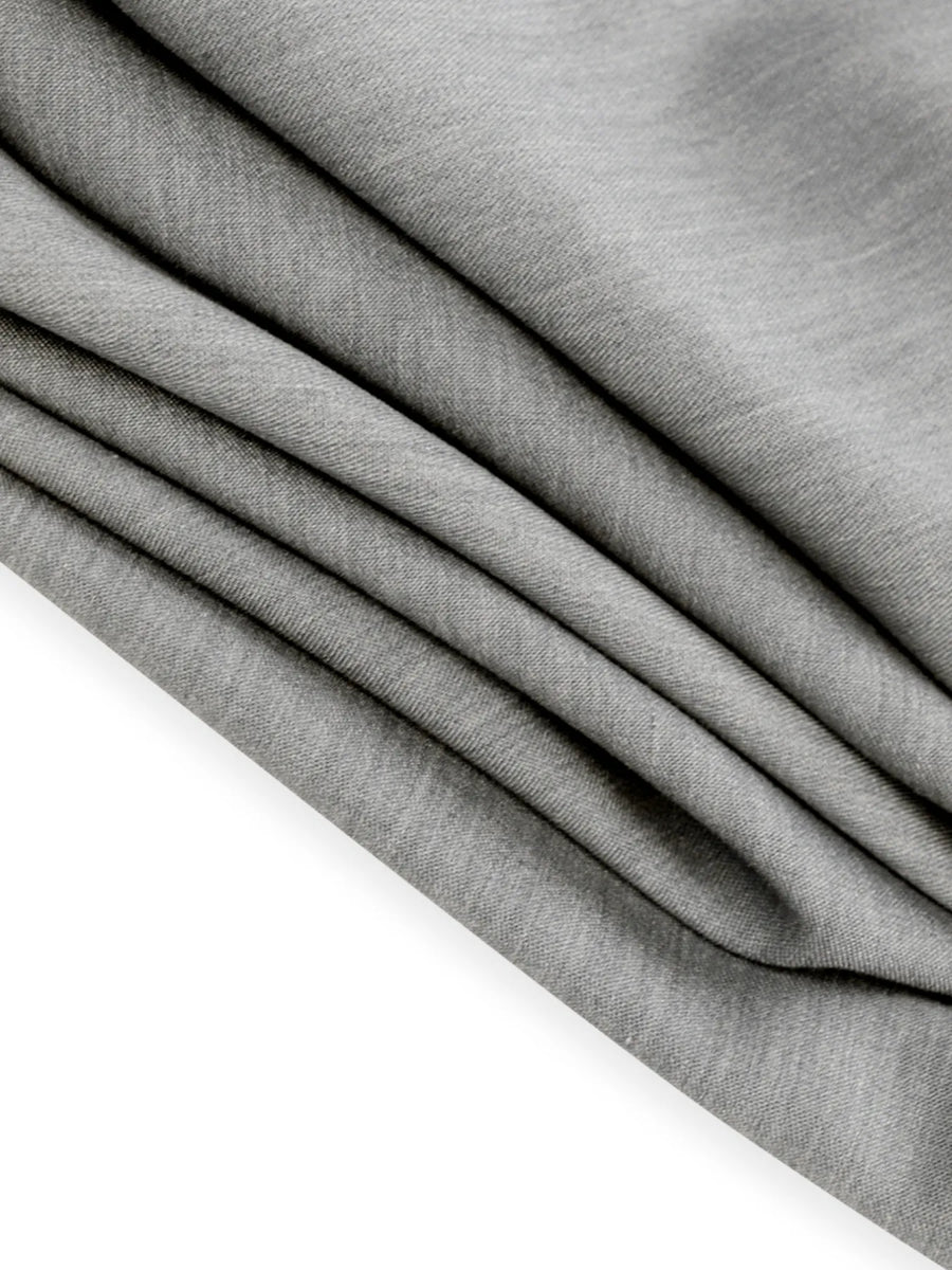 Close-up of gray fabric with a slight texture on a white background