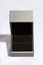 Silver jewelry box with a textured lid on a white background