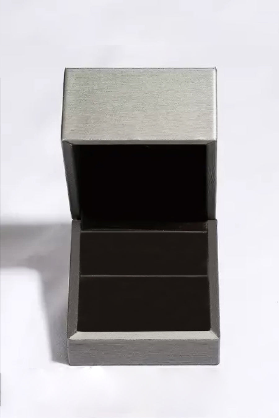 Silver jewelry box with a textured lid on a white background