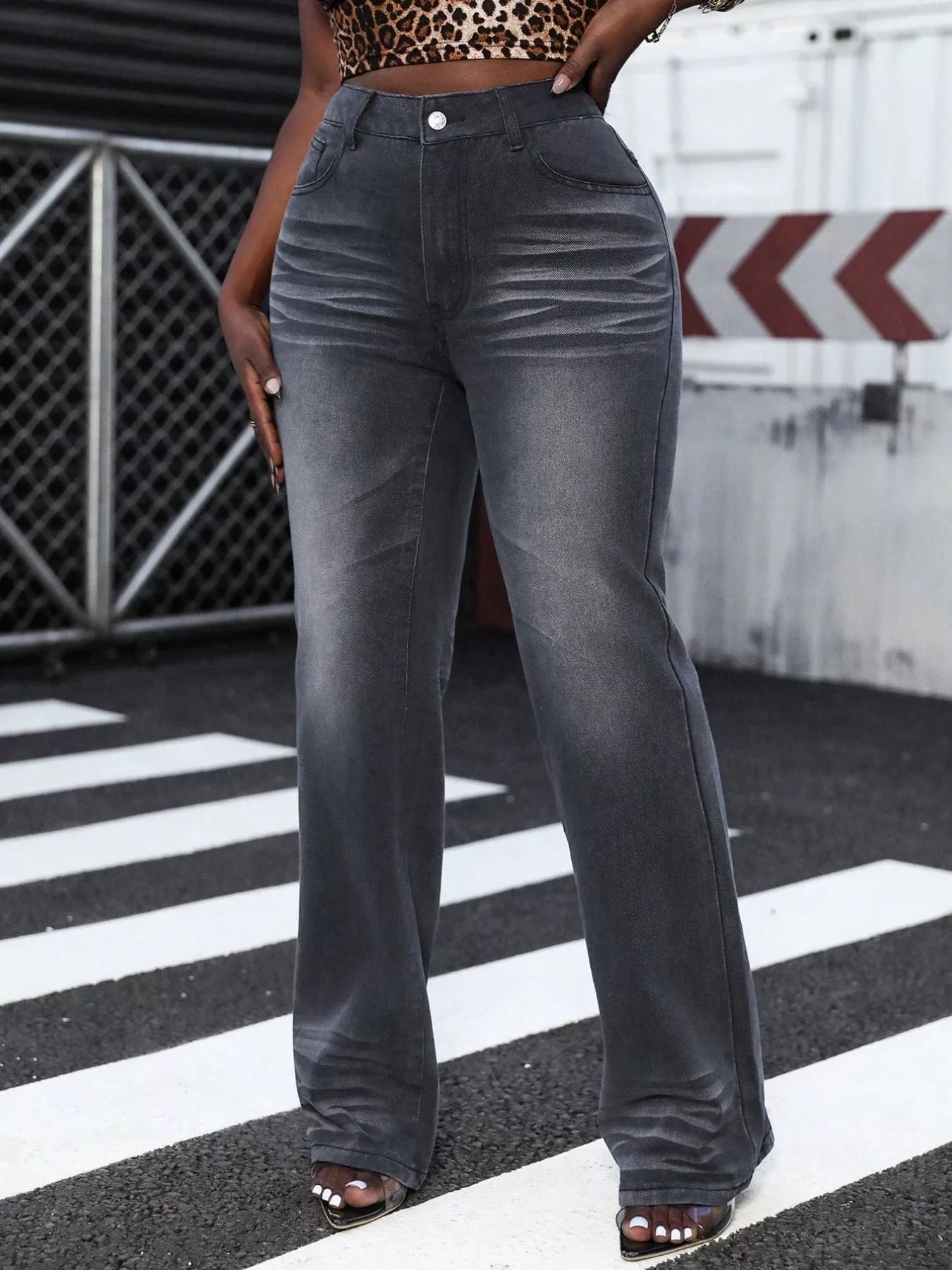 Person wearing gray wide-leg jeans on a zebra crossing