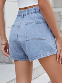 Light blue denim shorts worn by a person on a neutral background
