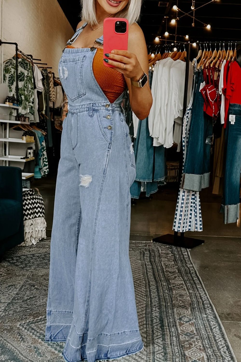 Person wearing a denim dress in a clothing store.