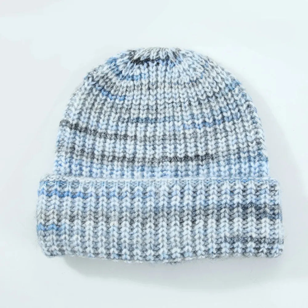 Knitted beanie with blue and gray pattern on a white background