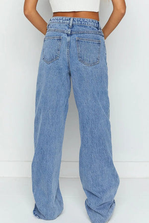 Blue jeans worn by a person on a white background