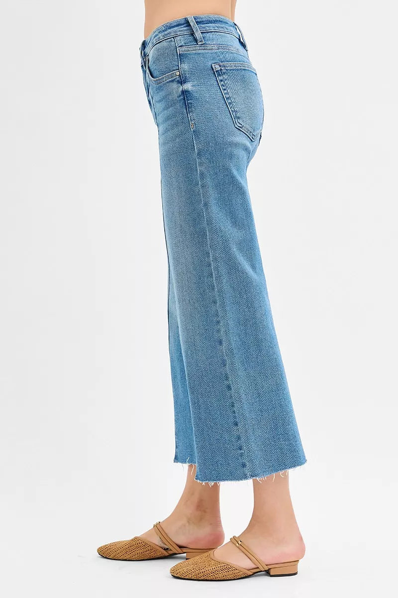 Blue jeans worn by a person on a white background