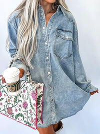 Person wearing a denim shirt with a floral bag and coffee cup on a white background