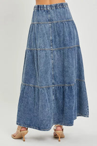 Denim skirt with tiered design on a plain background