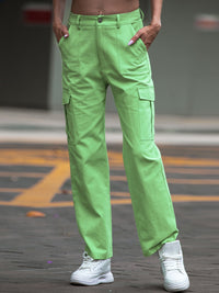 Person wearing bright green cargo pants with a blurred background