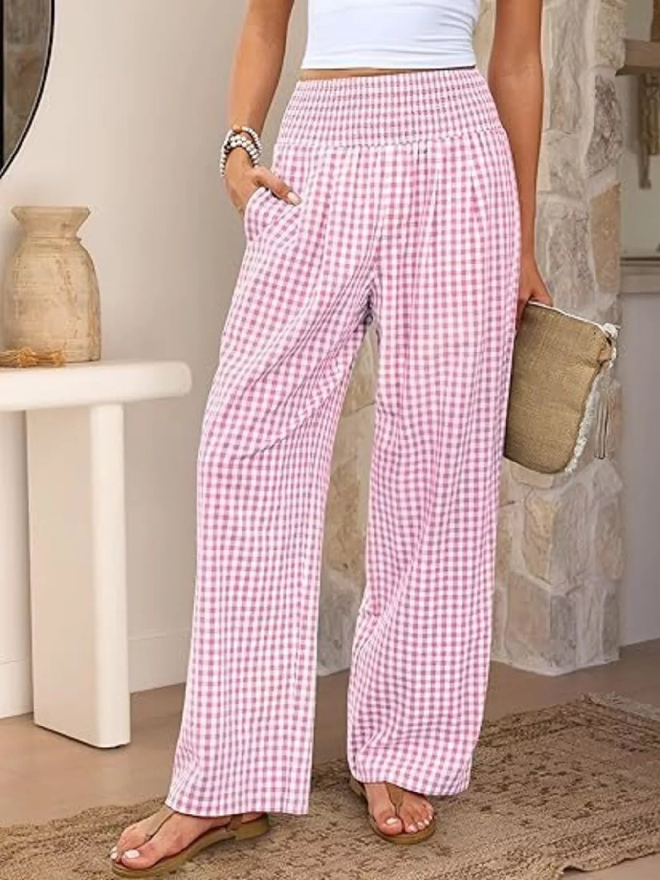 Person wearing pink checkered pants in a home setting