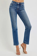 Blue jeans worn by a person on a white background