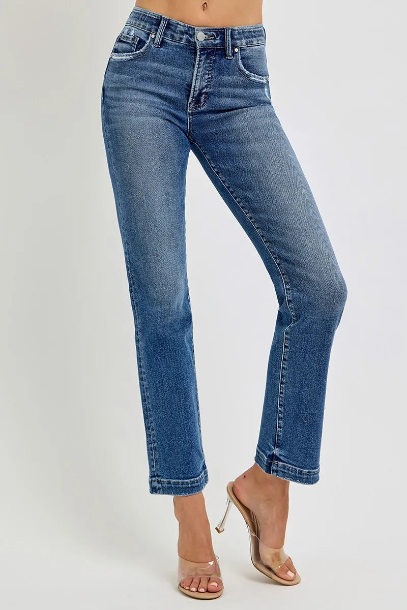 Blue jeans worn by a person on a white background