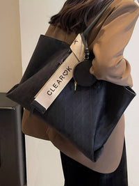 Person holding a black bag with 'CLEARQX' branding against a neutral background