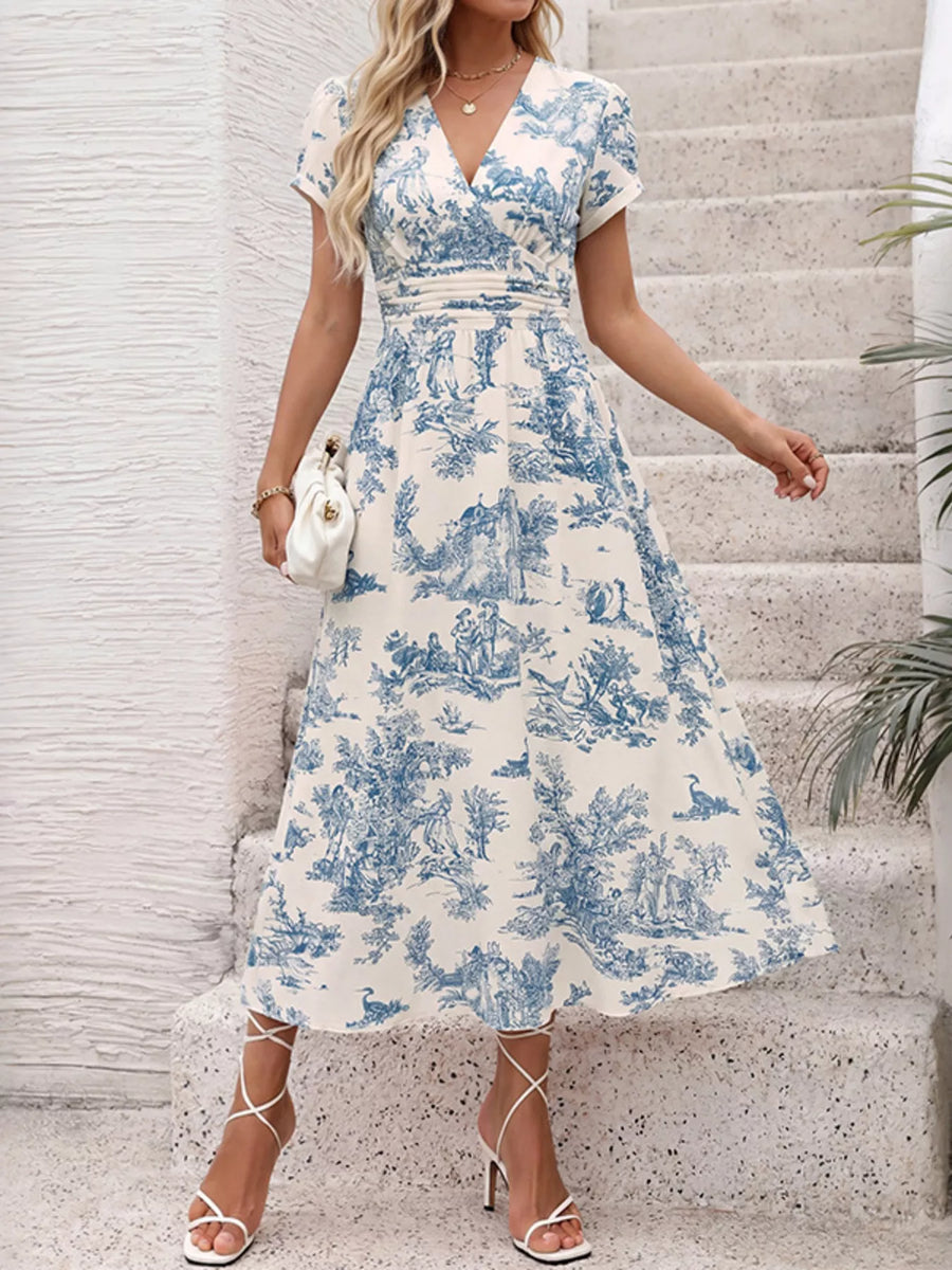 Woman wearing a blue and white floral dress on stone steps.