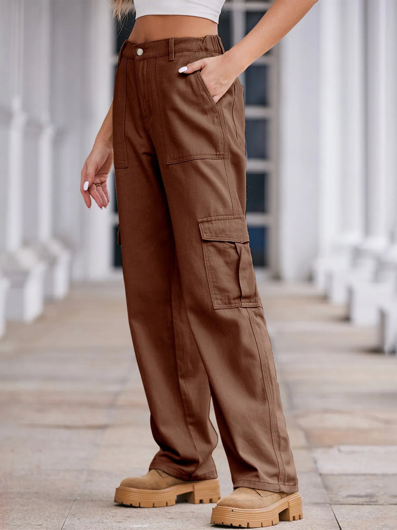 Brown cargo pants worn by a person on a blurred indoor background