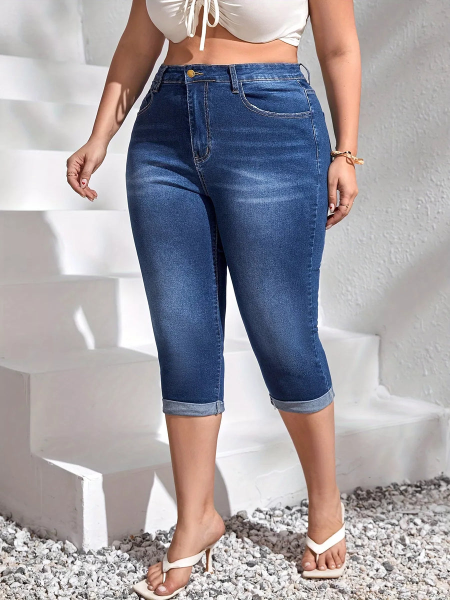 Person wearing blue jeans standing on a white staircase.