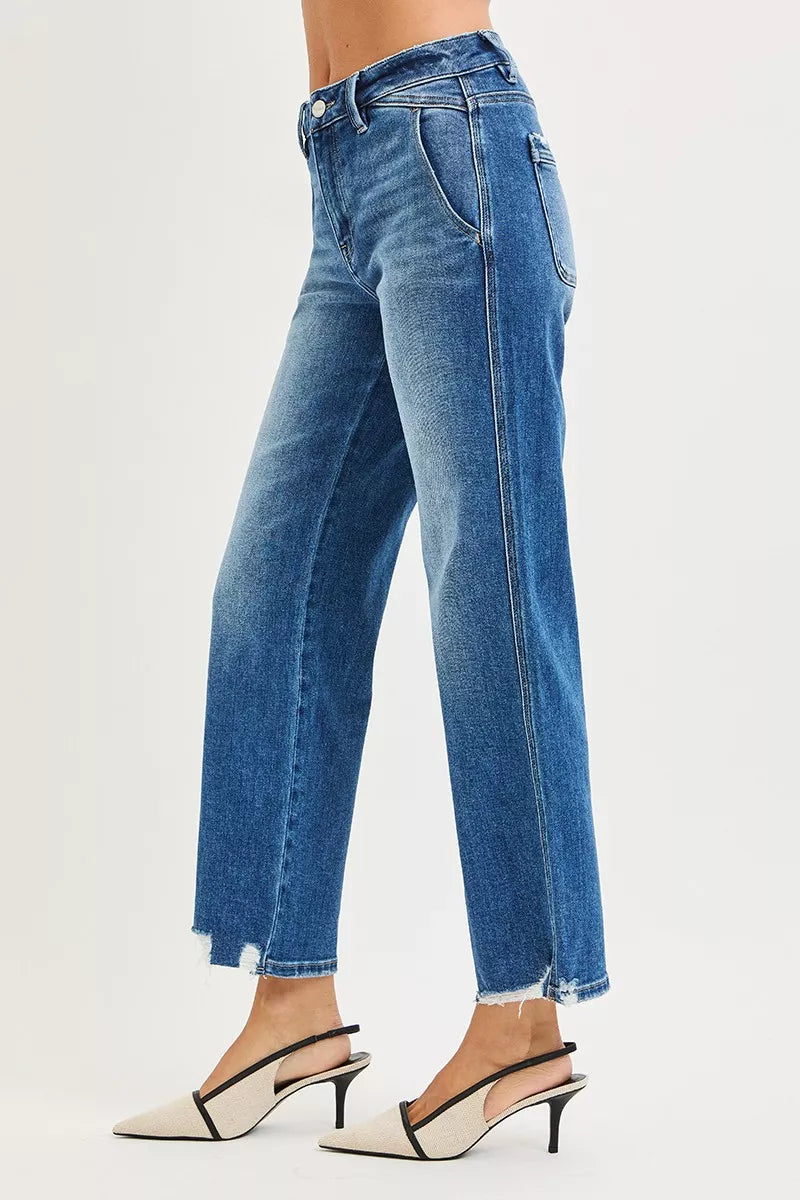Blue jeans worn by a person on a white background