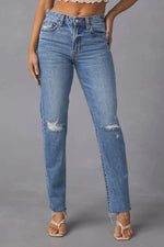 Blue jeans with slight distressing on a gray background
