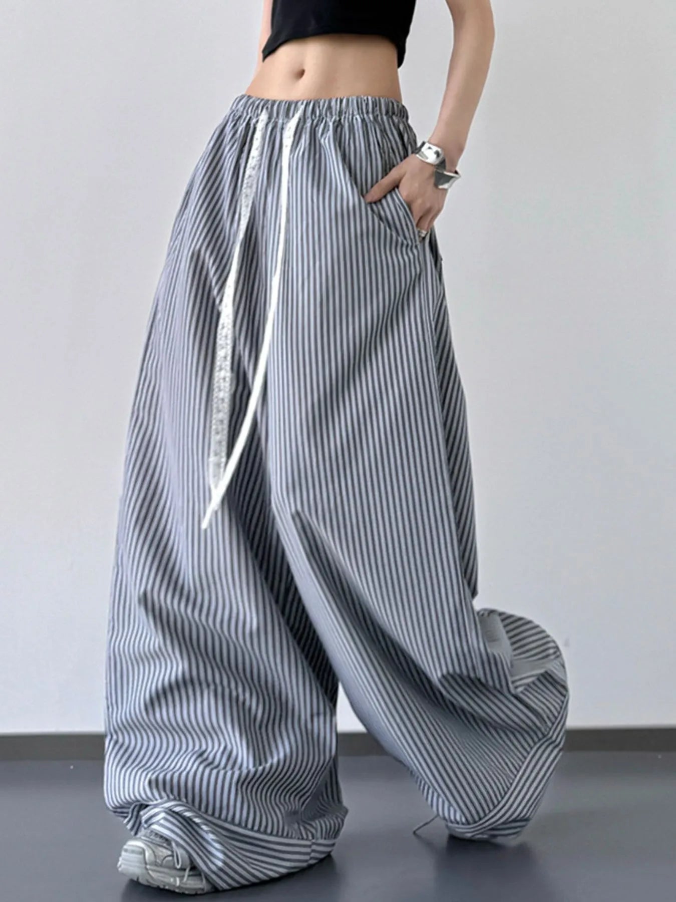 Striped wide-leg pants worn by a person on a plain background
