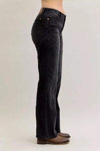 Black jeans worn by a person on a plain background