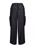 Black wide-leg cargo pants with an elastic waistband, featuring flap pockets on the upper thighs and side cargo pockets, shown against a plain white background.
