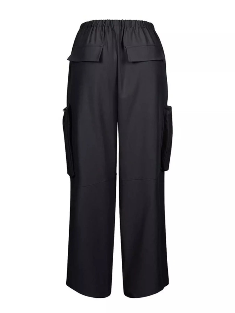 Black wide-leg cargo pants with an elastic waistband, featuring flap pockets on the upper thighs and side cargo pockets, shown against a plain white background.