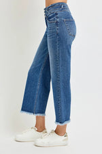 Blue jeans worn by a person on a white background
