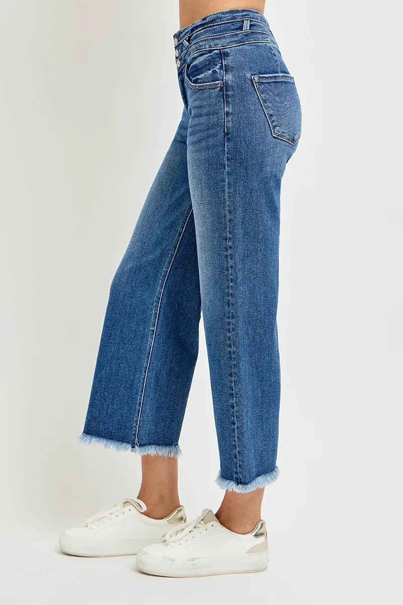 Blue jeans worn by a person on a white background