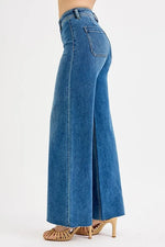 Blue jeans worn by a person on a white background