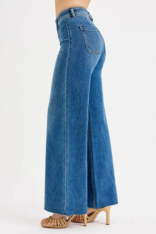 Blue jeans worn by a person on a white background