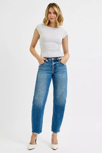 Woman wearing a white top and blue jeans on a white background