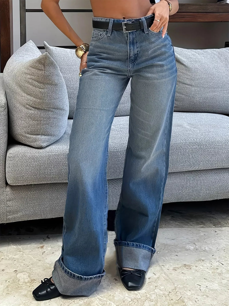 Person wearing blue jeans in a living room setting