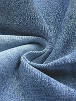 Close-up of blue denim fabric with visible texture