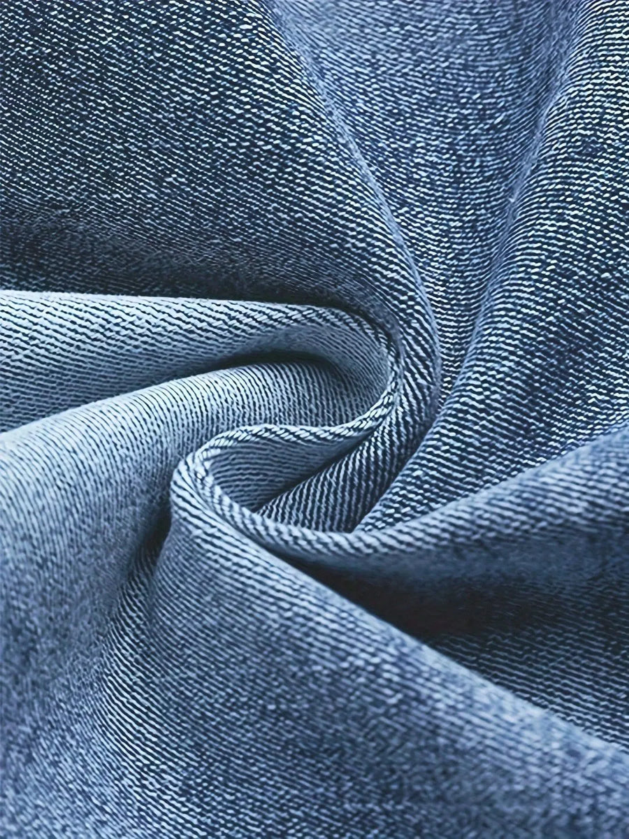 Close-up of blue denim fabric with visible texture