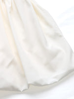 Close-up of white fabric with a subtle texture on a white background