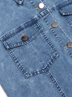 Close-up of a blue denim jacket with button details