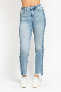 Light blue jeans worn by a person on a white background