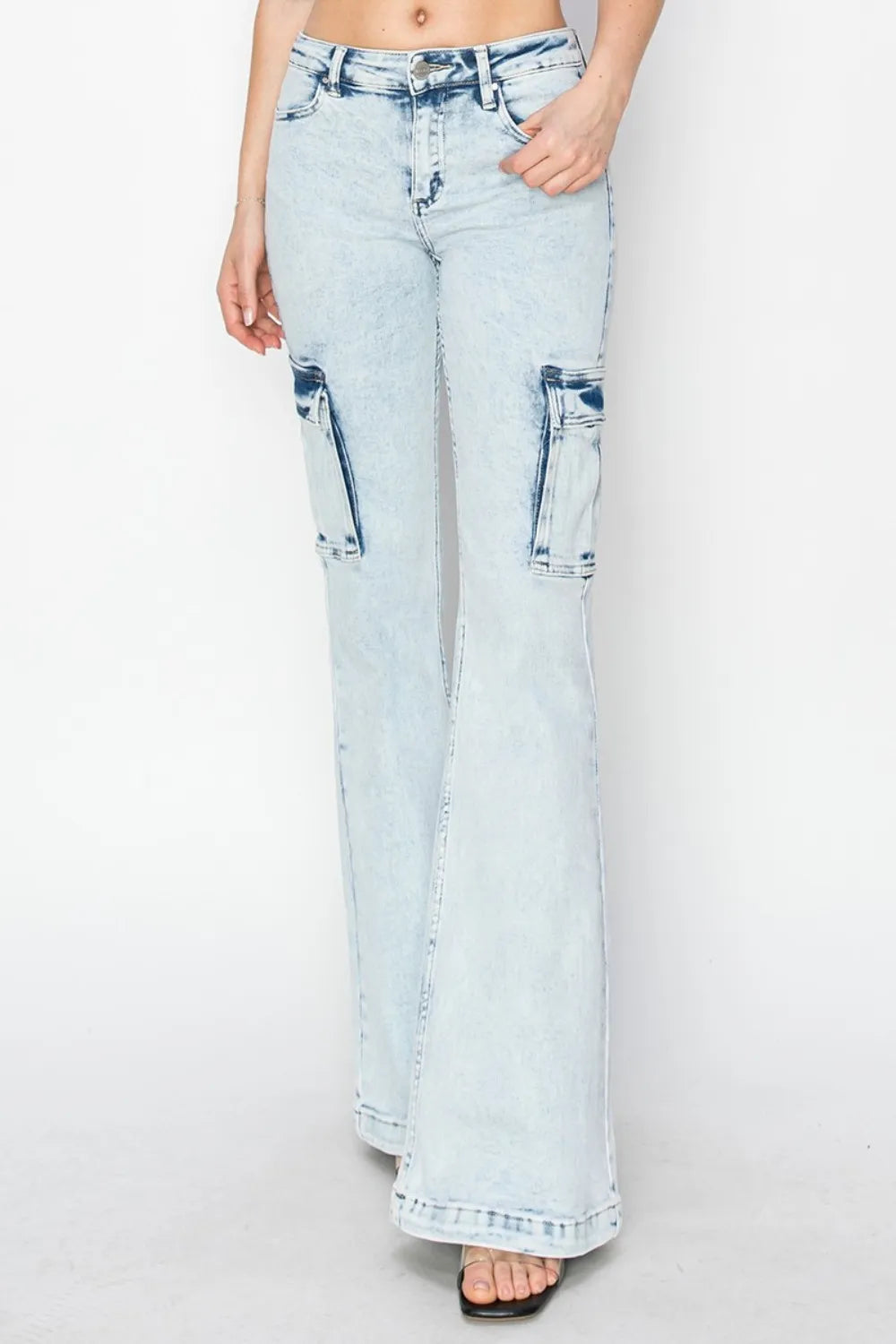Light blue jeans with distressed details on a white background