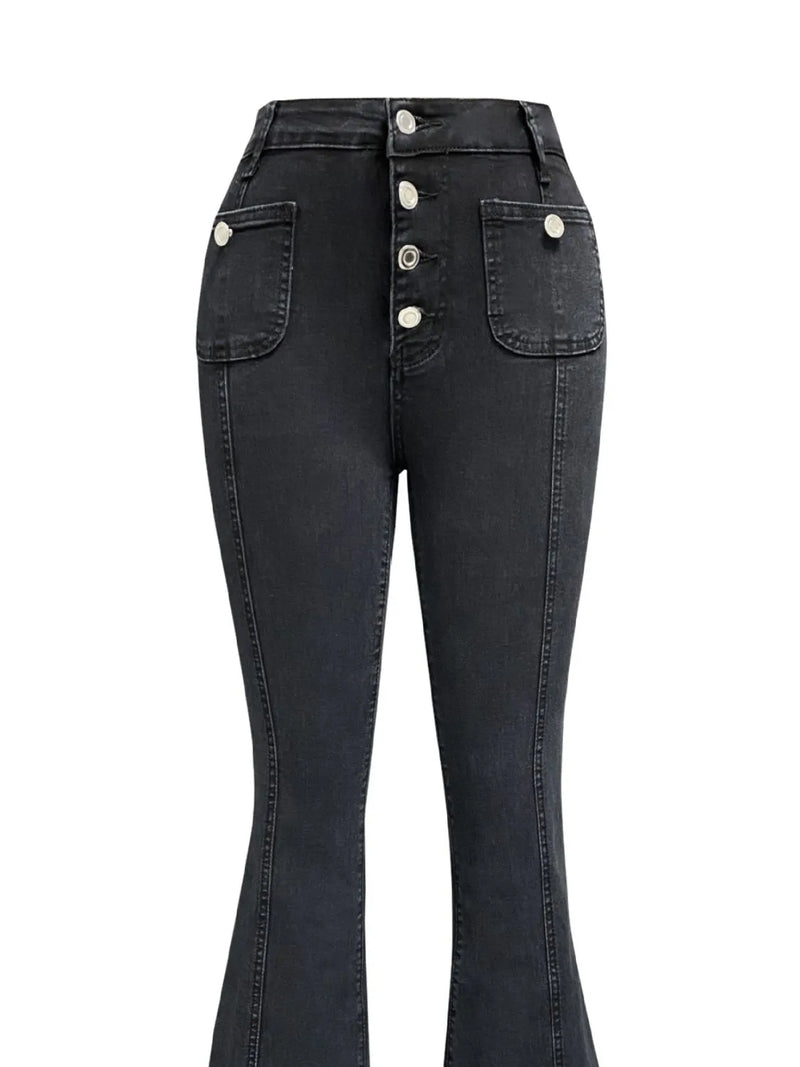 Black jeans with button details on a white background