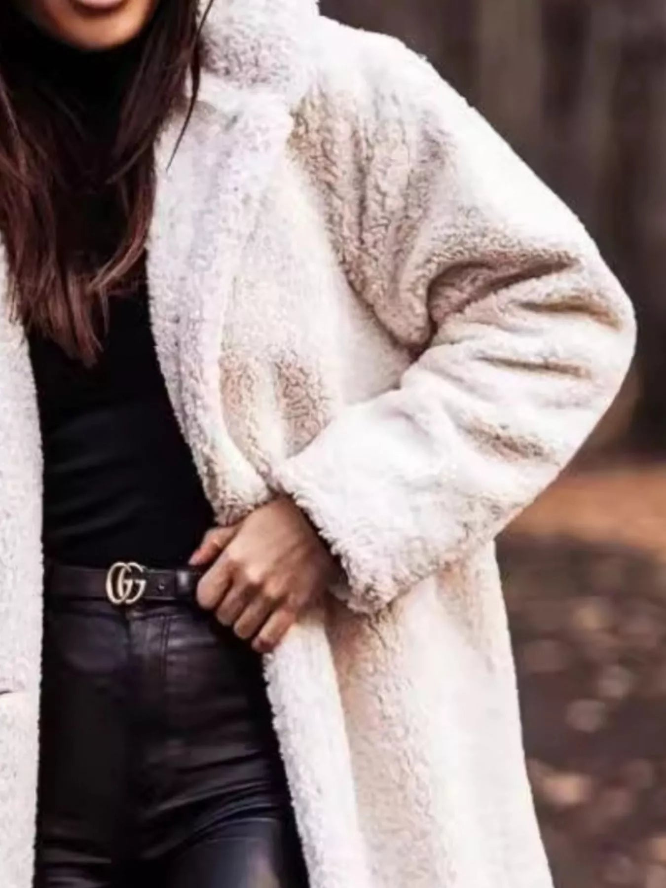 Person wearing a white fluffy coat with a blurred background